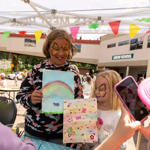 Kid showing off a painting